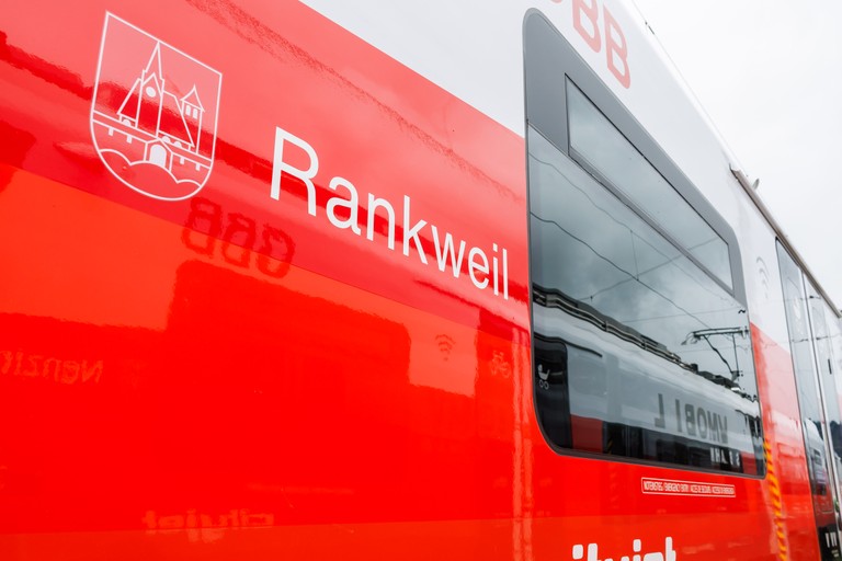 ÖBB-Regionalmanager Marcus Ender und Landesrat Daniel Zadra vor der Zuggarnitur mit dem Rankweil-Wappen (©Land Vorarlberg/Bernd Hofmeister)