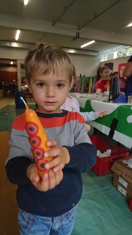 Die Kinder betrachteten stolz ihre selbst-gezogene Kerze